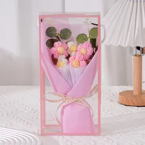 Handmade crochet daisy flower bouquet showcased in a clear pink gift box, exquisite detail view.