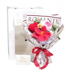 Detailed view of handmade knitted flower bouquet with romantic gift bag and card
