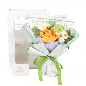 Detailed close-up view of a handmade crochet flower bouquet with gift bag and card
