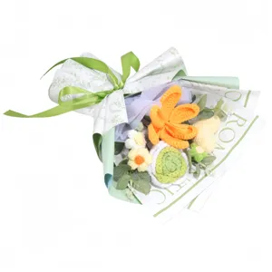 Detailed view of handmade crochet flower bouquet with green ribbon and wrapping paper