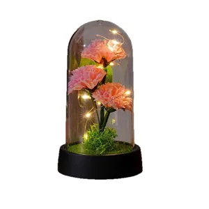 Artificial carnation flower LED night light with glass dome for home decor and holiday gifts.