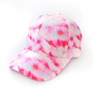 Close-up detail of the stylish tie-dye baseball cap showing vibrant pink and white pattern.