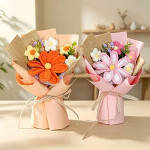 Close-up of two exquisite handmade crochet cosmos flower bouquets in peach and pink wrapping