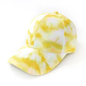 Detailed close-up view of the yellow tie-dye baseball cap, showing fine fabric texture.