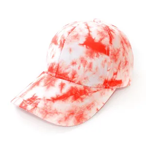 Detail view of the red and white tie dye baseball cap showing texture and curved brim.
