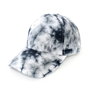 Close-up detail of the black and white tie-dye baseball cap with curved brim and fine stitching.