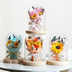 Detailansicht von vier verschiedenen konservierten Sonnenblumensträußen in Glasdomen