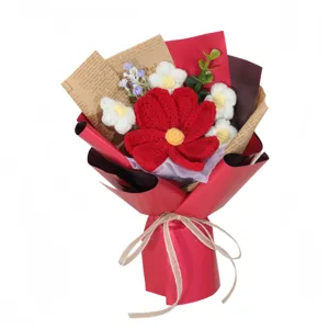 Closeup detail of handmade crochet flower bouquet with red and white blooms in elegant wrap.