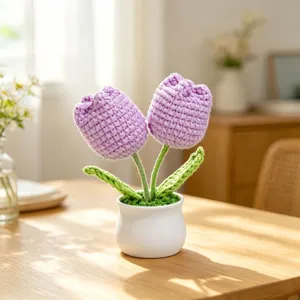 Detail of handmade crochet purple tulip potted plant in a white pot for desktop decor