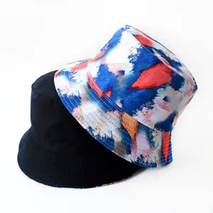 Reversible bucket hat with abstract print and solid black design, ideal for sun protection outdoor.
