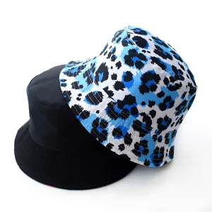 Reversible bucket hat detail showing blue leopard print and solid black sides for casual wear.