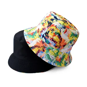Closeup detail view showing reversible bucket hat with colorful abstract paint print and solid black.