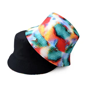 Detailed view of reversible bucket hat with colorful abstract print and solid black side.