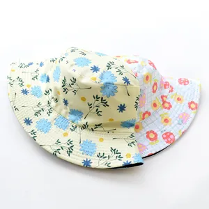 Two reversible bucket hats with floral and ladybug patterns on a clean white background.