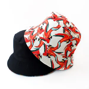 Detailed view of double-sided fashion bucket hat with abstract red print and solid black.