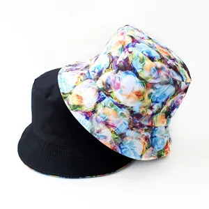 Detailed close-up view of reversible bucket hat, black solid and colorful floral sides.