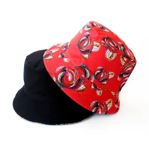 Reversible bucket hat with abstract digital print and solid black side, casual sun protection.