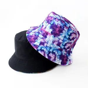 Detailed view of reversible bucket hat, black and purple tie-dye design, outdoor casual style.