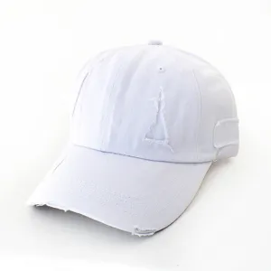 Detailed view of the white distressed baseball cap showing frayed edge and textured canvas.