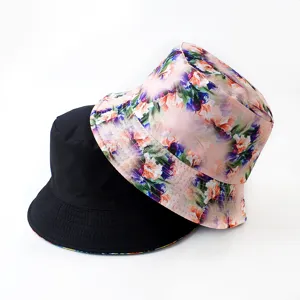 Detailed view of reversible bucket hat with black and digital floral print options.