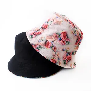 Double-sided bucket hat with floral print and black solid style, casual outdoor sun protection.