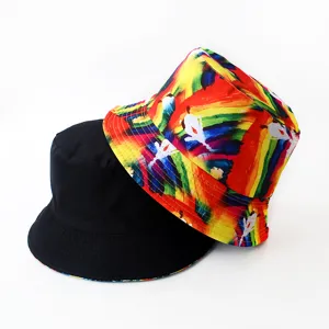 Detailed view of reversible bucket hats, featuring one solid black side and a vibrant print.