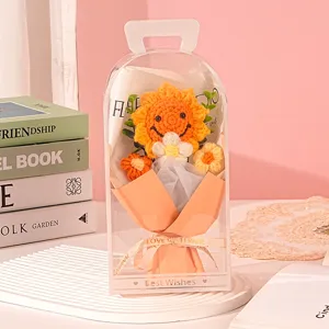 Detailed macro view of handmade knitted sunflower bouquet in a transparent PVC gift box