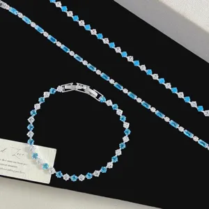 Elegant blue bubble zircon jewelry set with baguette cut stones on black background