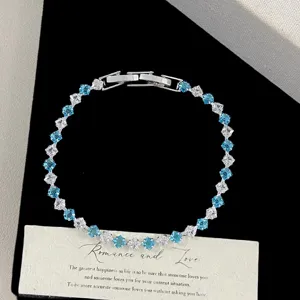 Detail of blue and clear square zircon bracelet with silver clasp on elegant prop card