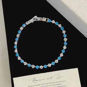 Elegant bracelet with square blue turquoise and sparkling white zirconia stones.