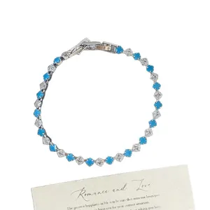 Elegant silver-tone bracelet featuring alternating blue and clear square zircon stones