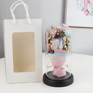 Detail view of eternal rose glass dome with dried gypsophila, elegant gift packaging.