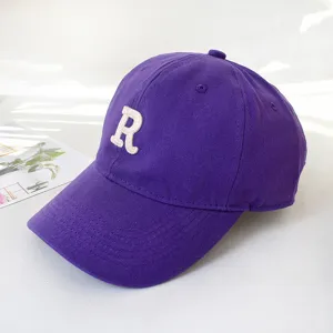 Detailed side view of a purple cotton baseball cap featuring a white embroidered letter R