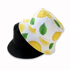 Reversible bucket hat detail showcasing fresh yellow lemon print and solid black side.