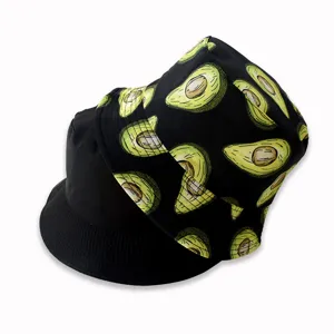 Close-up detail of the trendy reversible bucket hat featuring a fun avocado print and solid black.