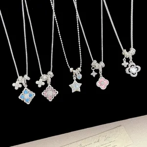 Detailed view of silver-plated clover and star necklaces with colorful zircon pendants.