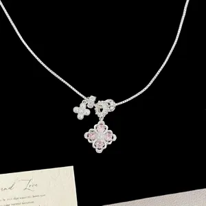 Exquisite close-up of silver necklace with pink zircon four-leaf clover and pearl charms