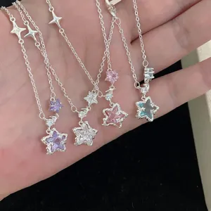 Close-up of four star pendant necklaces with colorful sparkling cubic zirconia