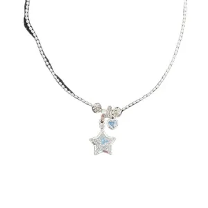 Dainty silver necklace with sparkling star and heart pendants featuring blue stones