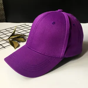 Side view detail showing the fabric texture of a plain purple cotton baseball cap