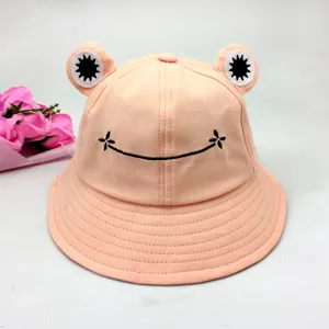 Cute pink frog bucket hat close-up detail, featuring lovely embroidery and funny eyes.