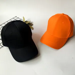 Pair of classic black and vibrant orange baseball caps for sun protection and fashion