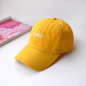 Yellow baseball cap for women and men, classic soft top dad hat with white embroidery text.