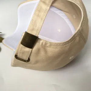 Back view of a beige cotton baseball cap with adjustable metal buckle strap
