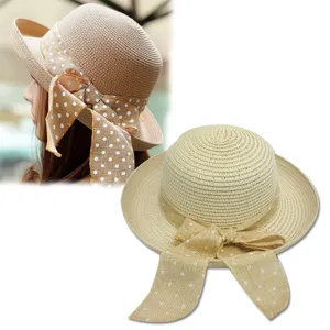 Elegant women's wide brim straw sun hat featuring a chic polka dot ribbon bow for beach vacations