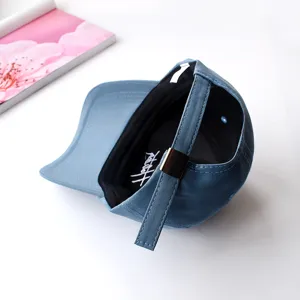 Blue baseball cap with metal adjustable strap and internal graphic detail for daily casual wear.