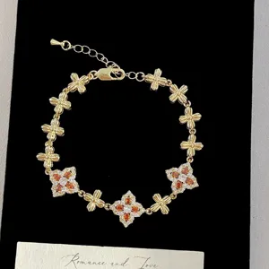 Detailed macro view of vintage French style gold bracelet with colorful crystal floral motifs