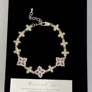 Macro detail of a luxurious French vintage gold bracelet with purple crystal flowers