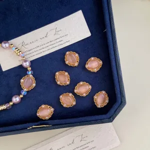 Detail view of purple pearl bracelet with elegant pink stone charms in a velvet box.