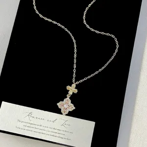 Detailed close-up of a French retro gold necklace featuring a sparkling pink and white floral pendant